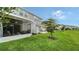Screened patio with lush lawn and distant treeline at 8533 Lunar Skye St, Sarasota, FL 34241