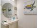Stylish bathroom with pedestal sink and framed artwork at 8533 Lunar Skye St, Sarasota, FL 34241