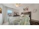 Main bedroom with large bed, window, and ceiling fan at 8533 Lunar Skye St, Sarasota, FL 34241