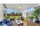 Relaxing lanai with wicker furniture, potted plants, and view of nature at 8533 Lunar Skye St, Sarasota, FL 34241