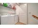 Bright laundry room with washer, dryer, and shelving at 8533 Lunar Skye St, Sarasota, FL 34241