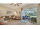 Bright living room with comfy seating and access to a lanai at 8533 Lunar Skye St, Sarasota, FL 34241