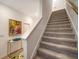 Modern staircase with carpeted steps and neutral wall colors at 8533 Lunar Skye St, Sarasota, FL 34241