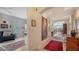 Spacious hallway with hardwood floors, artwork, and access to multiple rooms at 888 S Orange Ave # 3D, Sarasota, FL 34236