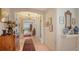 Bright hallway with hardwood floors, arched doorways, and art at 888 S Orange Ave # 3D, Sarasota, FL 34236