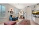 Home office with built-in shelving, comfortable seating, and a large TV at 888 S Orange Ave # 3D, Sarasota, FL 34236