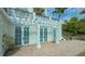 Ground level patio with white pergola and access to the building at 888 S Orange Ave # 3D, Sarasota, FL 34236