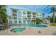 Community pool and spa with lounge chairs and patio furniture at 888 S Orange Ave # 3D, Sarasota, FL 34236