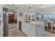 Modern kitchen with island, white cabinets, and stainless steel appliances at 9203 Griggs Rd # B304, Englewood, FL 34224