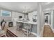 Modern kitchen with white cabinets, stainless steel appliances, and an island at 9203 Griggs Rd # B304, Englewood, FL 34224