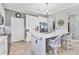 Modern kitchen with white cabinets, stainless steel appliances, and an island at 9203 Griggs Rd # B304, Englewood, FL 34224