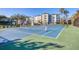 Well-maintained paddle tennis court with building in background at 9203 Griggs Rd # B304, Englewood, FL 34224