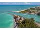 Aerial view of a beautiful coastline with a jetty and boats at 104 Capri Isles Blvd # 112, Venice, FL 34292