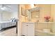 Bathroom with vanity and large mirror at 104 Capri Isles Blvd # 112, Venice, FL 34292