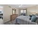 Second bedroom with a dresser and sliding door to patio at 104 Capri Isles Blvd # 112, Venice, FL 34292