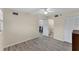 Spacious bedroom with ceiling fan and access to bathroom and another room at 104 Capri Isles Blvd # 112, Venice, FL 34292