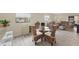 Charming dining area with glass table and wicker chairs at 104 Capri Isles Blvd # 112, Venice, FL 34292