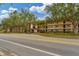 Condo building exterior showcasing street and landscaping at 104 Capri Isles Blvd # 112, Venice, FL 34292