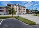Exterior view of building with parking and landscaping at 104 Capri Isles Blvd # 112, Venice, FL 34292
