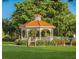 Relaxing gazebo with benches in landscaped area at 104 Capri Isles Blvd # 112, Venice, FL 34292