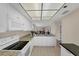 Bright kitchen features granite countertops, white cabinetry, and modern appliances at 104 Capri Isles Blvd # 112, Venice, FL 34292