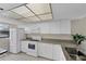 Bright kitchen with white cabinets and ample counter space at 104 Capri Isles Blvd # 112, Venice, FL 34292