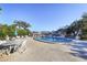 Community pool with lounge chairs and a nearby restroom at 104 Capri Isles Blvd # 112, Venice, FL 34292