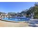 Community pool with lounge chairs and a nearby restroom at 104 Capri Isles Blvd # 112, Venice, FL 34292