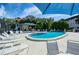 Community pool with ample lounge chairs and umbrellas at 104 Capri Isles Blvd # 112, Venice, FL 34292