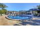 Community pool with lounge chairs and a nearby restroom at 104 Capri Isles Blvd # 112, Venice, FL 34292