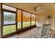 Relaxing screened porch with rocking chairs and view of parking lot at 104 Capri Isles Blvd # 112, Venice, FL 34292