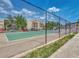 Community tennis court with chain link fence at 104 Capri Isles Blvd # 112, Venice, FL 34292