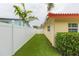 Artificial turf backyard with a white fence at 1110 2Nd S Ave, Tierra Verde, FL 33715