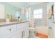 Clean bathroom with granite countertop, white cabinets, and a shower/tub combo at 1110 2Nd S Ave, Tierra Verde, FL 33715