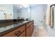 Bathroom with dark granite countertop and subway tile shower at 1110 2Nd S Ave, Tierra Verde, FL 33715