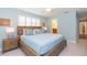 Main bedroom features a wooden bed frame and light blue walls at 1110 2Nd S Ave, Tierra Verde, FL 33715