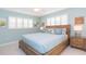 Main bedroom with light blue walls and wooden bed frame at 1110 2Nd S Ave, Tierra Verde, FL 33715