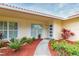 Inviting home exterior featuring a landscaped walkway and modern front door at 1110 2Nd S Ave, Tierra Verde, FL 33715