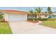 Updated Florida ranch home with a large driveway and mature landscaping at 1110 2Nd S Ave, Tierra Verde, FL 33715