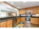 Kitchen boasts wood cabinets, granite counters, and stainless steel appliances at 1110 2Nd S Ave, Tierra Verde, FL 33715