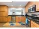 Kitchen features wood cabinets, granite counters, and stainless steel appliances at 1110 2Nd S Ave, Tierra Verde, FL 33715