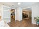 Bright living room with hardwood floors, and a view into the kitchen and dining area at 1110 2Nd S Ave, Tierra Verde, FL 33715
