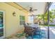 Covered patio with seating area, dining table, and ceiling fan at 1110 2Nd S Ave, Tierra Verde, FL 33715