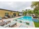 Relaxing pool area with patio furniture and lush landscaping at 1110 2Nd S Ave, Tierra Verde, FL 33715