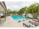 Beautiful pool with swim-up seating and surrounding patio at 1110 2Nd S Ave, Tierra Verde, FL 33715