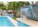 Waterfall feature flows into refreshing blue pool at 1110 2Nd S Ave, Tierra Verde, FL 33715