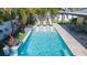 Large rectangular pool with swim-up seating and fire features at 1110 2Nd S Ave, Tierra Verde, FL 33715
