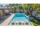 Relaxing pool area with built-in seating and fire bowls at 1110 2Nd S Ave, Tierra Verde, FL 33715
