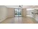 Bright living room with tile floors and sliding glass doors leading to a balcony at 1111 N Gulfstream Ave # 3E, Sarasota, FL 34236