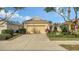 Front exterior view of a single-story house with a two-car garage and landscaped yard at 11808 Crawford Parrish Ln, Parrish, FL 34219